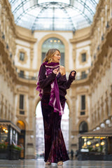 Model wearing a GONNA SBIECO VELLUTO in a stunning interior with elegant architecture.