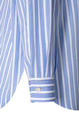 Close-up of a blue and white striped oversized shirt with Italian collar and buttoned cuff.