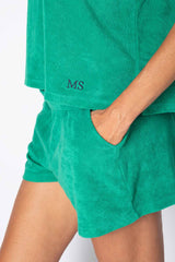 Comfortable green cotton lounge set with personalized initials, perfect for summer relaxation.