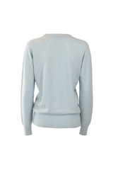 Back view of a soft blue cashmere crew neck sweater, featuring ribbed cuffs and hem.
