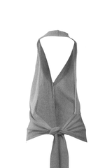 Elegant cashmere gilet with a tie closure and open back design, showcasing modern femininity and sophistication.