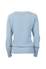 Back view of a light blue loose cashmere sweater with ribbed hem and relaxed fit.