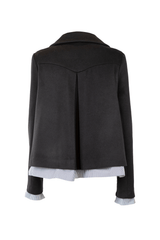 Back view of a stylish black cashmere peacoat, featuring a unique trapeze cut and elegant collar.