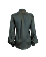 Back view of a feminine silk shirt with soft lines and slightly puffed sleeves.