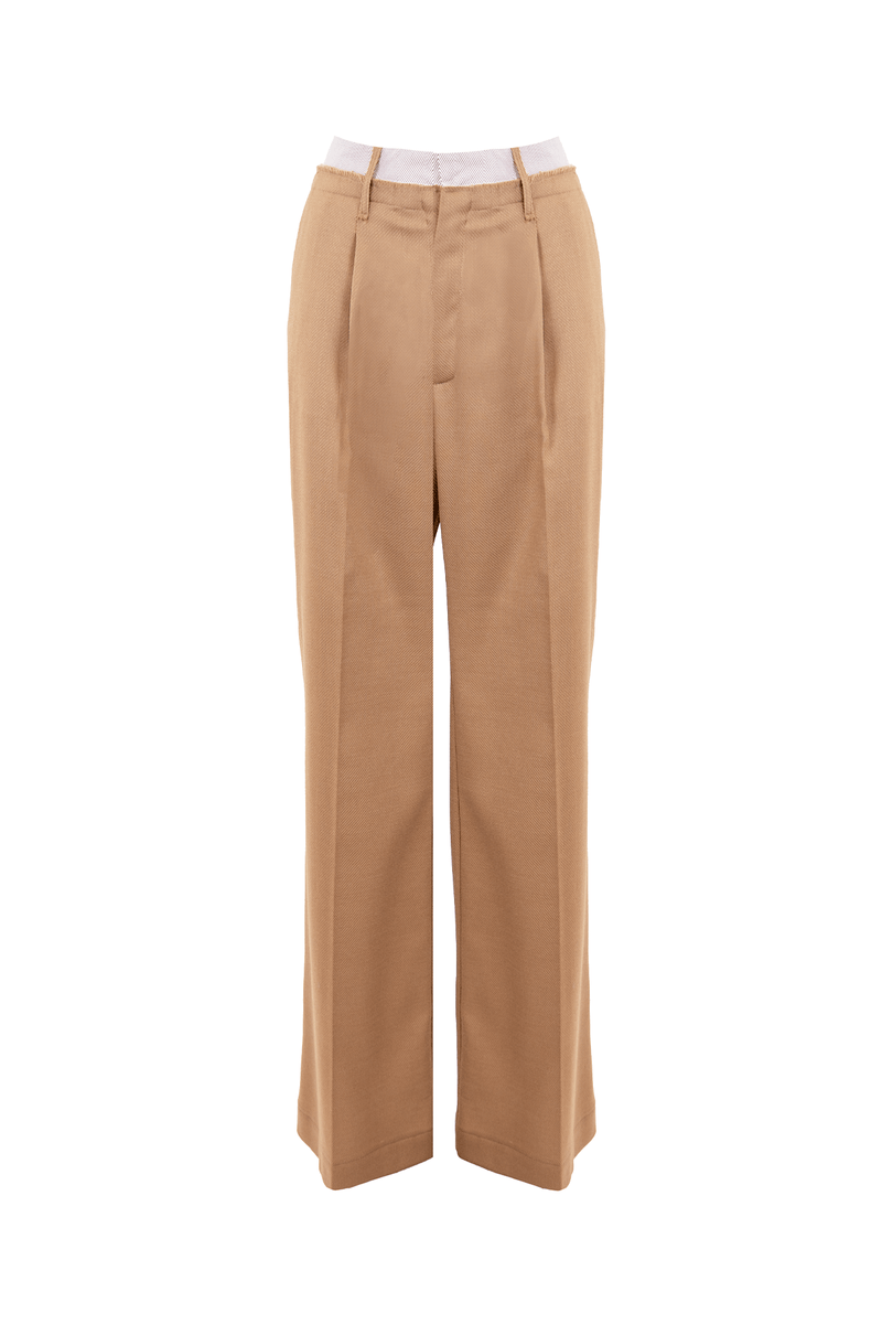 Ample wool pants in camel color with a contrasting striped cotton waistband, showcasing a sophisticated and contemporary style.